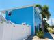 Side view of a light blue house with a white fence at 1826 58Th S St, Gulfport, FL 33707
