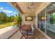 Covered patio with outdoor dining set and screens at 31275 Spruceberry Ct, Wesley Chapel, FL 33543