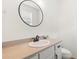 Small bathroom with a round mirror, single sink vanity, and toilet at 31275 Spruceberry Ct, Wesley Chapel, FL 33543