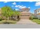 Two story house with a two car garage and landscaped yard at 31275 Spruceberry Ct, Wesley Chapel, FL 33543