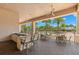 Outdoor kitchen and bar with seating overlooking the pool at 31275 Spruceberry Ct, Wesley Chapel, FL 33543