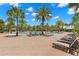 Expansive pool deck with numerous lounge chairs and umbrellas at 31275 Spruceberry Ct, Wesley Chapel, FL 33543