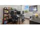 Home office featuring two desks, built-in shelving, and natural light at 31275 Spruceberry Ct, Wesley Chapel, FL 33543