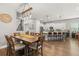 Bright dining area with wood table and chairs, open to kitchen at 31275 Spruceberry Ct, Wesley Chapel, FL 33543