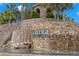 The Ridge at the Grass Ranch entrance features a stone facade, waterfall, and lush landscaping at 31275 Spruceberry Ct, Wesley Chapel, FL 33543