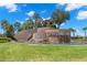 Community entrance with a stone waterfall feature and landscaping at 31275 Spruceberry Ct, Wesley Chapel, FL 33543