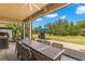 Relaxing covered patio with outdoor dining and backyard views at 31275 Spruceberry Ct, Wesley Chapel, FL 33543