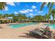Resort-style pool with lounge chairs and shaded seating areas at 31275 Spruceberry Ct, Wesley Chapel, FL 33543