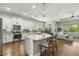 Open concept kitchen with island, stainless steel appliances, and hardwood floors at 31275 Spruceberry Ct, Wesley Chapel, FL 33543