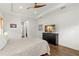 Main bedroom with hardwood floors, large window and TV at 31275 Spruceberry Ct, Wesley Chapel, FL 33543