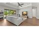 Living room with sectional sofa, hardwood floors, and sliding glass doors at 31275 Spruceberry Ct, Wesley Chapel, FL 33543