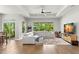 Spacious living room featuring a large sectional sofa and hardwood floors at 31275 Spruceberry Ct, Wesley Chapel, FL 33543