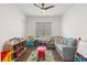 Fun playroom with a sofa, toys, and ample natural light at 31275 Spruceberry Ct, Wesley Chapel, FL 33543