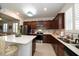 Well-equipped kitchen, featuring an island and dark wood cabinets at 20591 Monza Loop, Land O Lakes, FL 34638