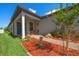Charming front porch with sitting area and well-manicured landscaping at 20591 Monza Loop, Land O Lakes, FL 34638