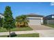 Attractive single-car garage with paver driveway and landscaping at 20591 Monza Loop, Land O Lakes, FL 34638