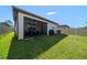 Spacious backyard with screened porch and grassy lawn at 20591 Monza Loop, Land O Lakes, FL 34638