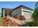 Beautiful home exterior with landscaped yard and attached garage at 20591 Monza Loop, Land O Lakes, FL 34638