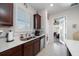 Kitchen with double sink, stainless steel appliances, and backyard access at 20591 Monza Loop, Land O Lakes, FL 34638
