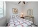 Bright bedroom with a cozy bed, dresser, and window shutters at 20591 Monza Loop, Land O Lakes, FL 34638