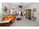 Bright living room featuring an orange sofa and decorative accents at 20591 Monza Loop, Land O Lakes, FL 34638