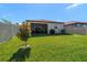 Large backyard with grassy lawn and screened porch at 20591 Monza Loop, Land O Lakes, FL 34638