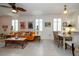 Open dining area with wood table and chairs, adjacent to living room at 20591 Monza Loop, Land O Lakes, FL 34638