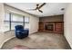Living room with brick fireplace, blue recliner, and bay window at 1811 Martin Rd, Dover, FL 33527