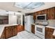Kitchen features wood cabinets, white appliances, and tile flooring at 1811 Martin Rd, Dover, FL 33527
