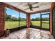 Screened porch with tiled floor and view of a large backyard at 1811 Martin Rd, Dover, FL 33527