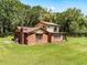 Rear view of two-story brick home, showcasing its size and layout at 1811 Martin Rd, Dover, FL 33527