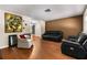 Spacious living room with hardwood floors and a large TV at 1811 Martin Rd, Dover, FL 33527