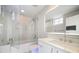 Modern bathroom with a glass enclosed tub, quartz countertop, and LED lighting at 100 Beach Ne Dr # 1900, St Petersburg, FL 33701