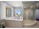 Bathroom with a large soaking tub, walk-in shower, and city views at 100 Beach Ne Dr # 1900, St Petersburg, FL 33701