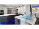 Modern kitchen with expansive island, stainless steel appliances, and blue LED lighting at 100 Beach Ne Dr # 1900, St Petersburg, FL 33701
