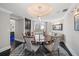 Elegant dining room with a circular table, hardwood floors, and city views at 100 Beach Ne Dr # 1900, St Petersburg, FL 33701