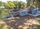 Spacious backyard with a large grassy area and a partially fenced perimeter at 5523 Carlton Rd, New Port Richey, FL 34652