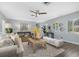 Spacious living room featuring hardwood floors, a ceiling fan, and ample natural light at 5523 Carlton Rd, New Port Richey, FL 34652