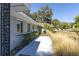 Gray house with walkway, landscaping, and a spacious yard at 5523 Carlton Rd, New Port Richey, FL 34652