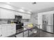 Modern kitchen with white cabinets, stainless steel appliances, and kitchen island at 5523 Carlton Rd, New Port Richey, FL 34652