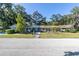 Ranch style home with a landscaped yard and driveway at 5523 Carlton Rd, New Port Richey, FL 34652