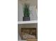 White shelf with decor, including a potted plant and inspirational sign at 5523 Carlton Rd, New Port Richey, FL 34652