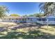 House's back view, showing a large backyard and partial fence at 5523 Carlton Rd, New Port Richey, FL 34652