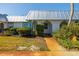 Exterior view of a condo with a metal roof and landscaped yard at 4239 Tamargo Dr, New Port Richey, FL 34652