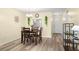 Dining area with hardwood floors and views of the kitchen and entryway at 4239 Tamargo Dr, New Port Richey, FL 34652