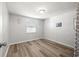 Simple bedroom with hardwood floors and a window with blinds at 4239 Tamargo Dr, New Port Richey, FL 34652