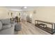 Living room with hardwood floors, gray sofa, and views to dining area at 4239 Tamargo Dr, New Port Richey, FL 34652