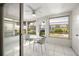 Sunroom with white tile floor, table and chairs, and view of backyard at 4239 Tamargo Dr, New Port Richey, FL 34652