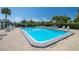 Community pool with lounge chairs and surrounding patio at 4239 Tamargo Dr, New Port Richey, FL 34652