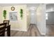 Hallway view with light flooring, pass-through kitchen window and access to other rooms at 4239 Tamargo Dr, New Port Richey, FL 34652